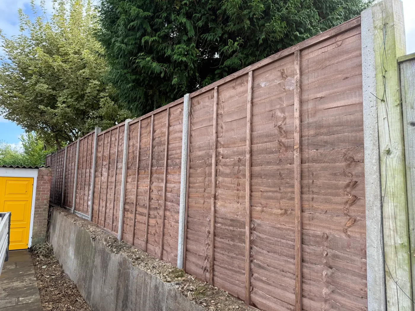 Garden boundary fencing installed behind a family home