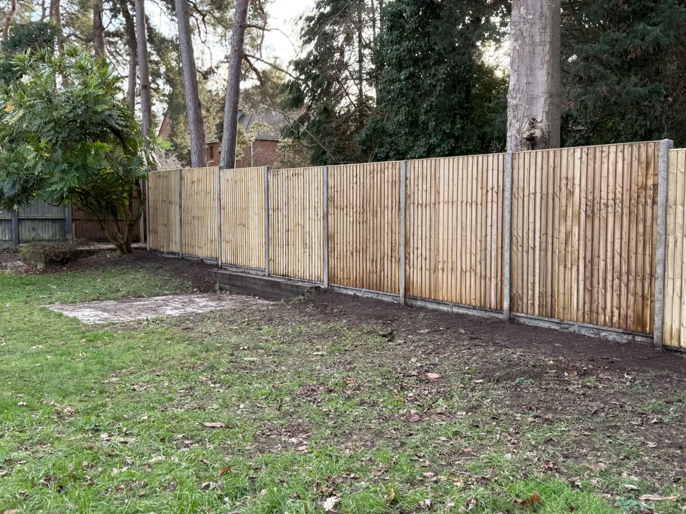 Long closeboard boundary fence installed in a large garden