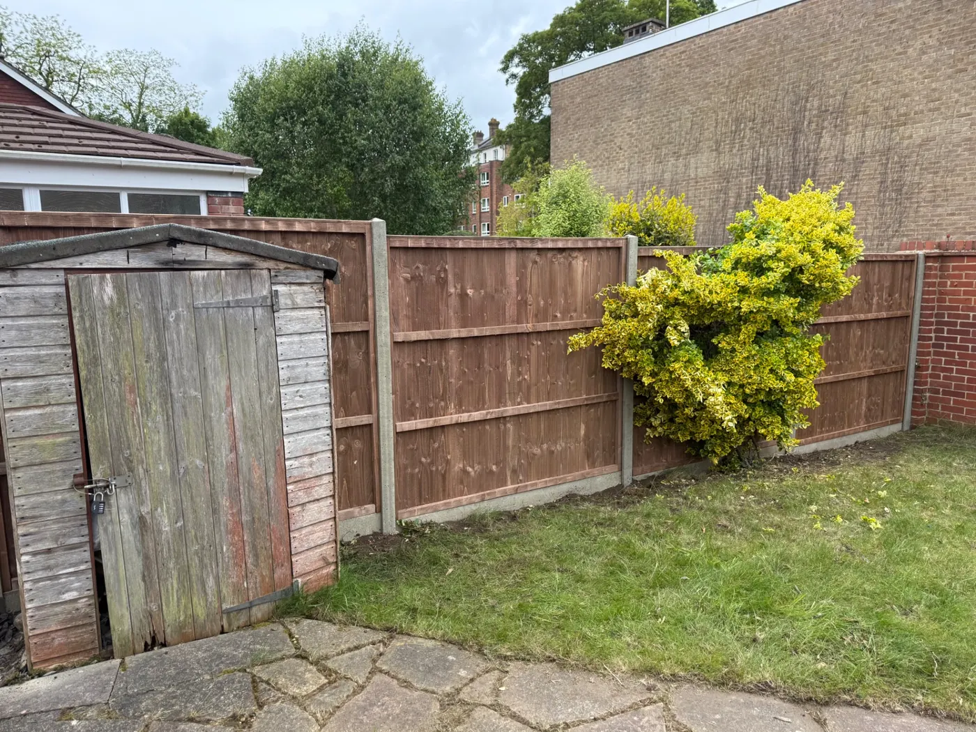 Old closeboard panels and posts cleared ready for replacement fencing