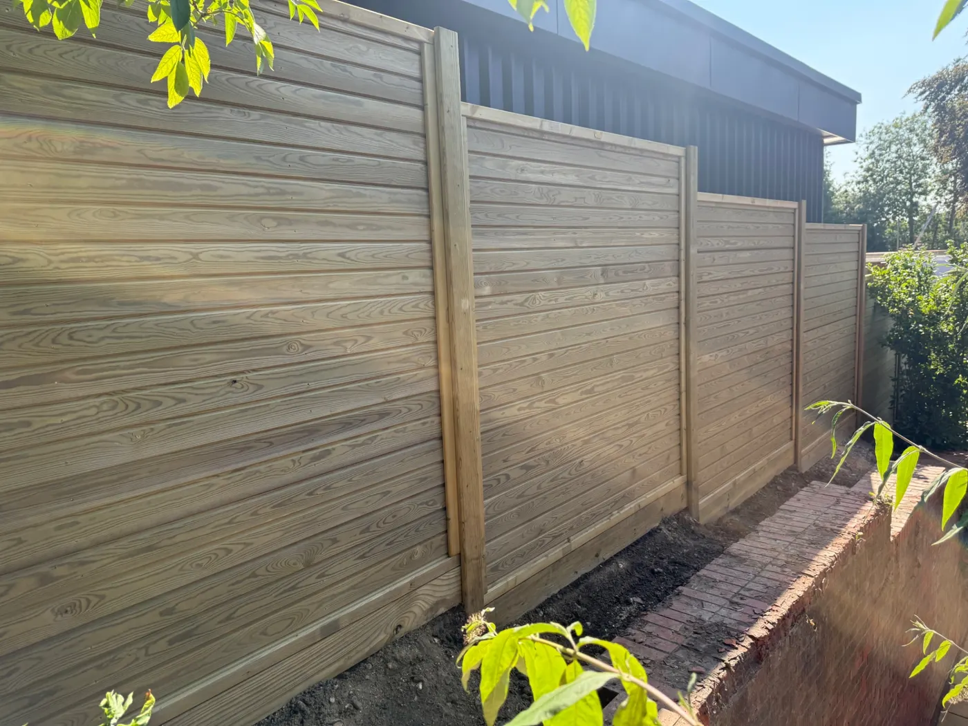Horizontal tongue and groove fence panels installed in a back garden