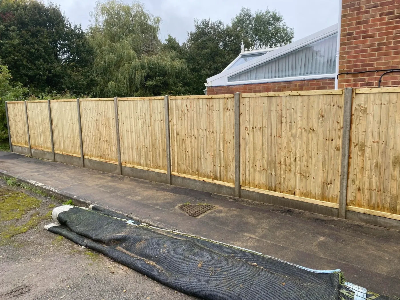 Tongue and groove fence panels fitted in a garden